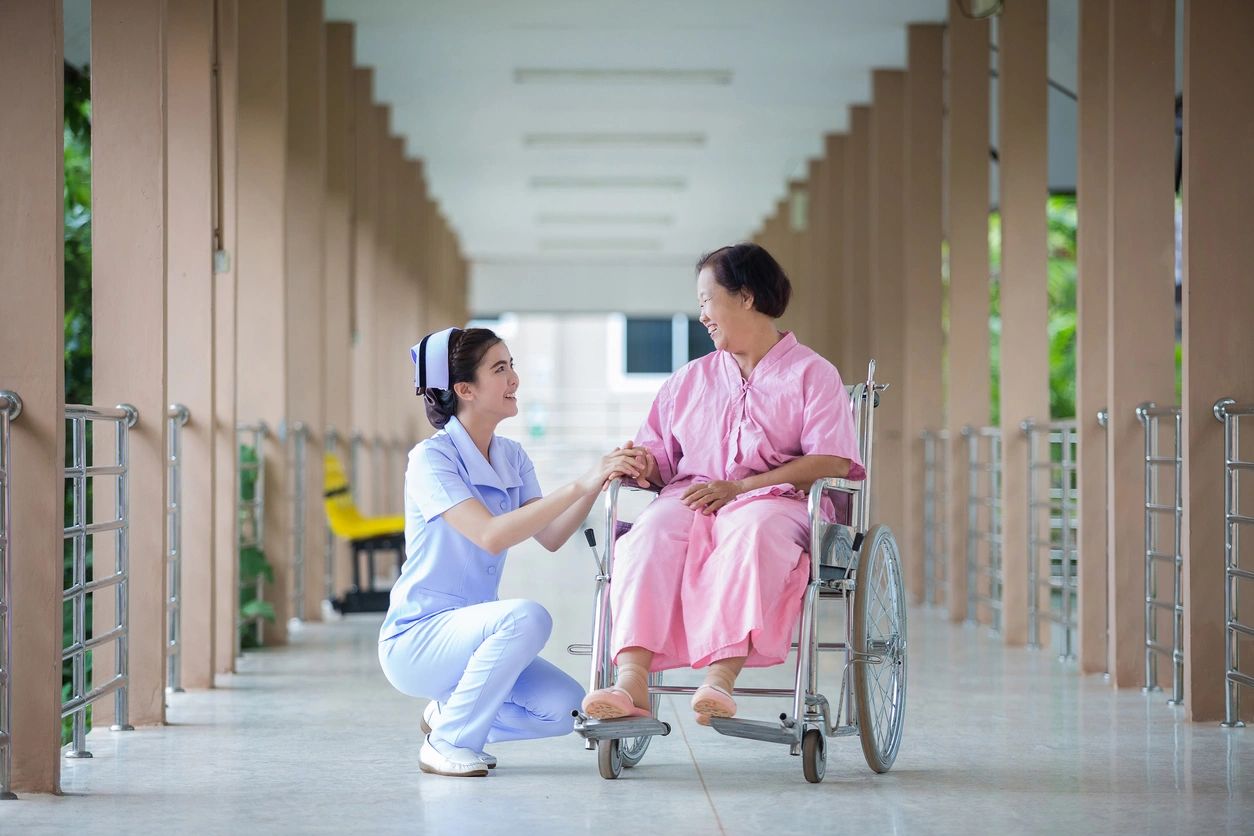 Nurse assisting a woman on a wheelchair